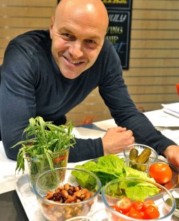 One of the celebrity chefs, Simon Rimmer, strikes a pose in the kitchen