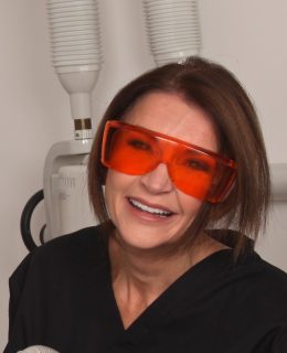 Dr Tracey Bell, pictured at work, warns of the dangers of dermal fillers