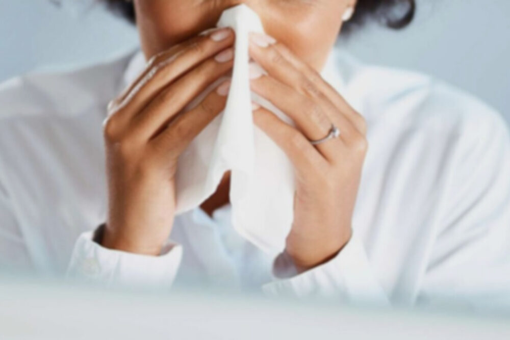 close-up of woman sneezing