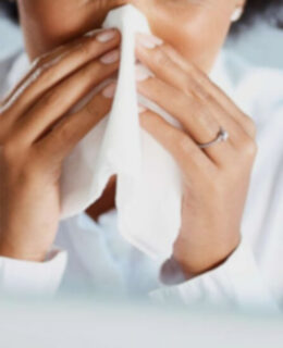 close-up of woman sneezing