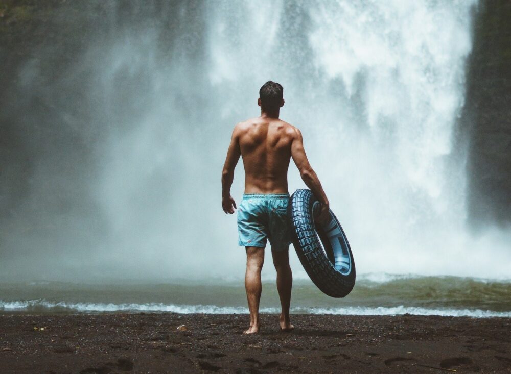 man by a waterfall