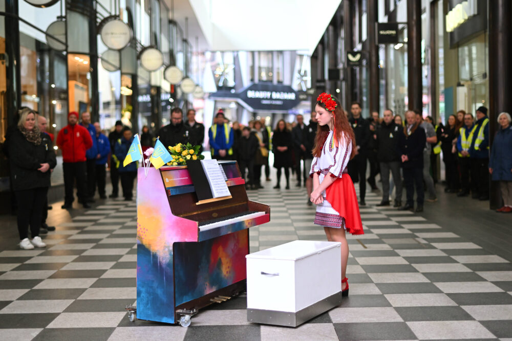 Alisa stands by the piano, Liverpool ONE
