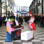 Alisa stands by the piano, Liverpool ONE