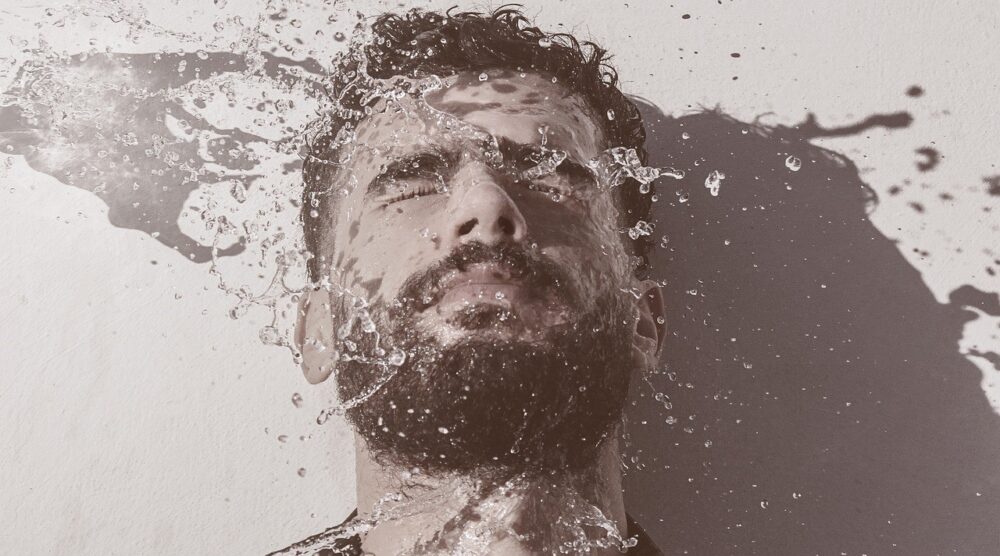man washing his face